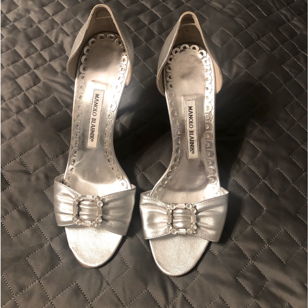 Manolo Blahnik silver shoes with crystal buckle.